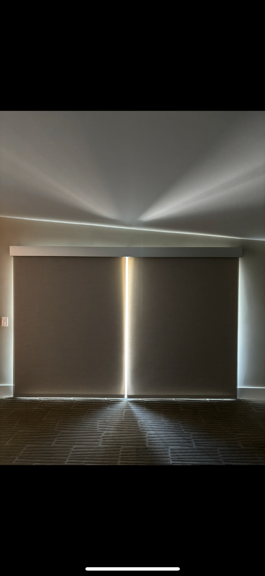 Room-darkening roller shades completed by Valley Screens